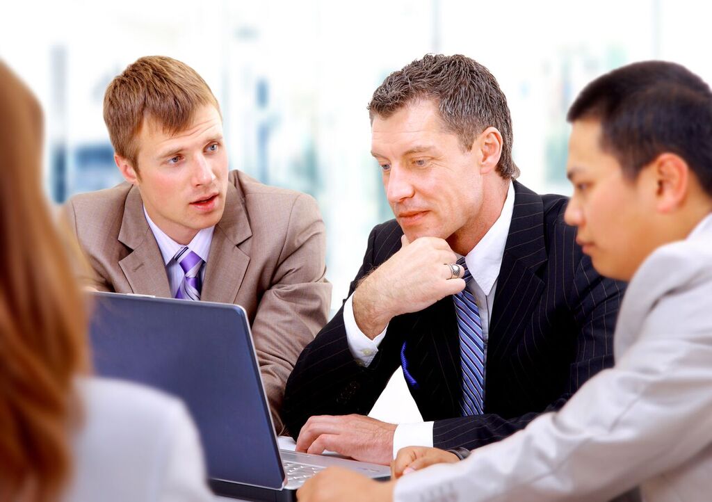 Identify a Strategy: Group of Men at Laptop