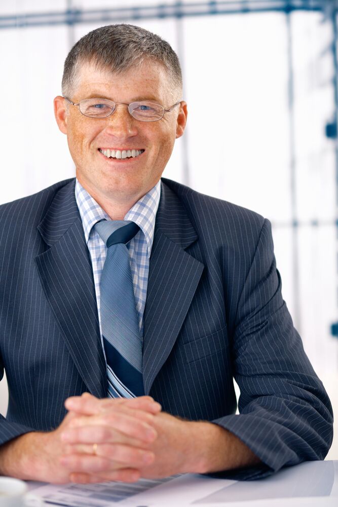 CEOs Productivity - businessman at desk_smiling