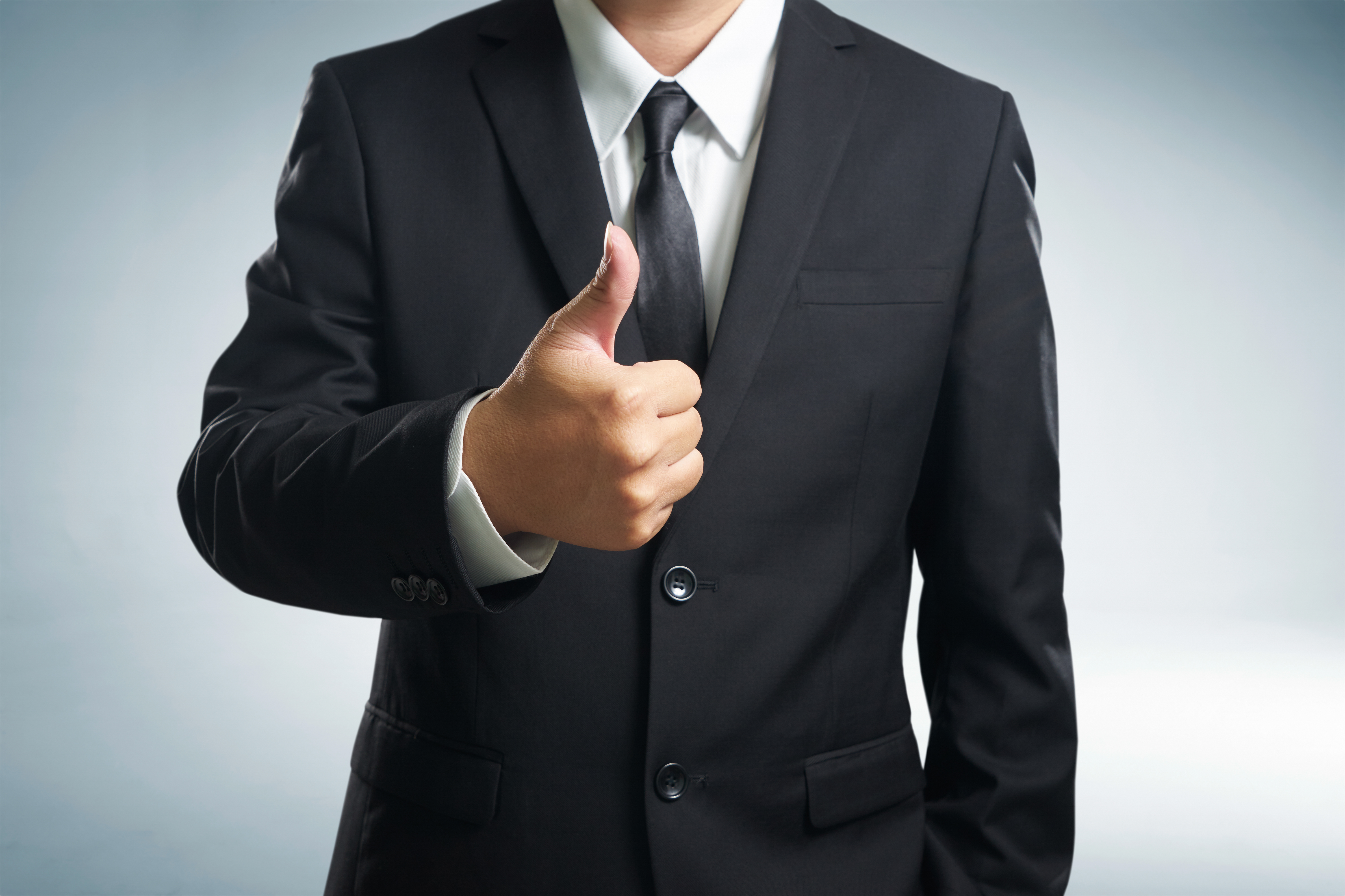 Retained Search Firms - Professional in suite with thumbs-up
