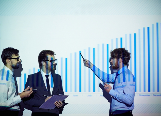 Confident businessman presenting his colleagues report of progress