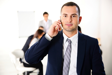 Businessman talking on the smartphone in front of business meeting