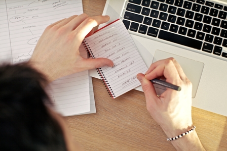 Benefits of Retained Executive Search - Woman at Laptop writing notes