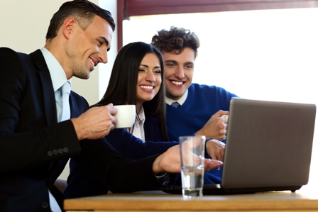 Determining-Company-Culture-During-Job-Interview-Smiling-Employees-at-Laptop-Computer
