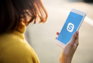 A woman using Skype application