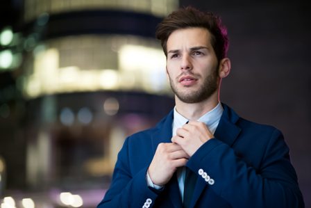 Man fixing tie