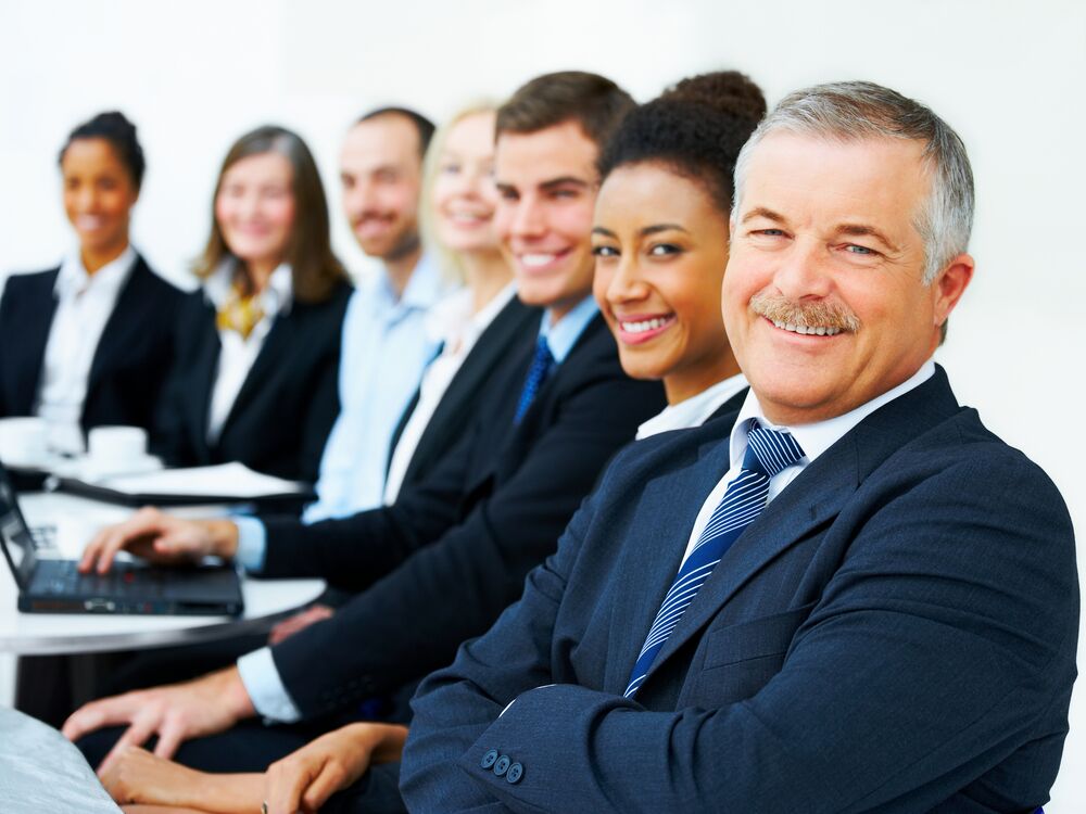 Emotional Intelligence - Group of business employees smiling