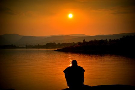 Person watching sunset on water